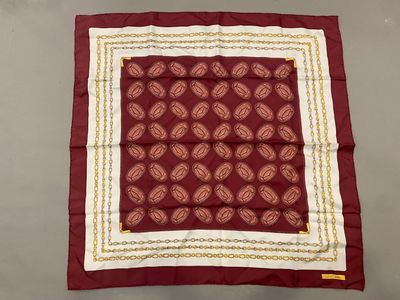 a red and white square with a gold border on it
