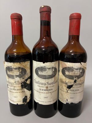 three bottles of wine sitting on top of a table next to each other