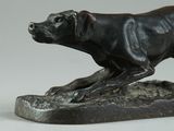 statue of a dog running on a rock on a white background