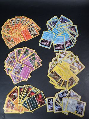 many pokemon cards laid out on a black surface