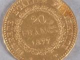 a close up of a gold coin on a white surface