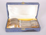 four spoons in a blue box with a gold handle