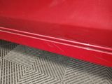 a close up of a red car door with a sticker on it
