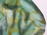 a close up of a green and yellow glass object
