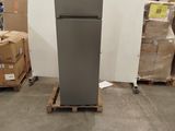a refrigerator that is sitting on a pallet in a warehouse