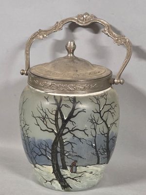 a glass jar with a lid that has a picture of a tree on it