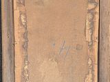 an old picture frame sitting on top of a wooden table next to a wall