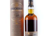 a bottle of knockando single malt whisky next to a cardboard box