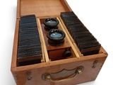 a wooden box with several different types of cameras in it