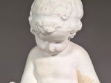marble statue of a young boy reading a book