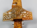 a very old and rusty cross on display on the wall
