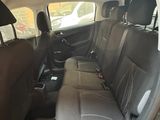 the back seat of a car with a black leather seat cover