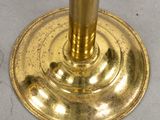a gold candle holder sitting on a white table