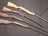 five different types of guns are lined up on a black cloth