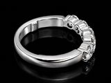 a close up of a diamond ring on a black surface