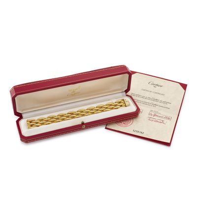 an image of a red box with a gold bracelet inside of it