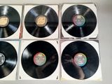 four black vinyl records are stacked on top of each other