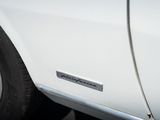 a close up of a white car with a sticker on it