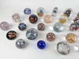 many different colored glass marbles on a white surface