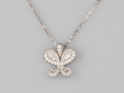 a diamond butterfly pendant on a chain