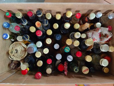 many bottles of beer in a cardboard box on the floor