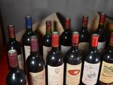 many bottles of wine in a wooden box on a red table
