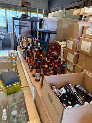 many boxes of alcohol on the counter in the store