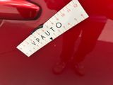a sticker on the back of a red car
