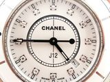 someone is holding a chanel watch in their hands