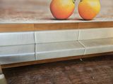 a picture of two oranges sitting on a bench
