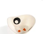 a white bowl with a black and orange face on it