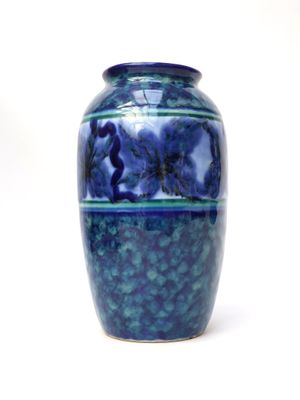 a blue vase that is sitting on a white surface