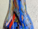 a glass vase with a blue and red design on it
