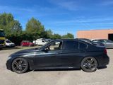 the bmw 3 series sedan is parked in a parking lot