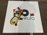 a white sign with a yellow cord attached to it