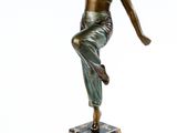 statue en bronze représentant une femme, posée sur un socle en marbre, les bras tendus