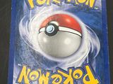 the pokemon news book is sitting on a black surface