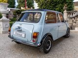a small blue car parked in front of a fountain
