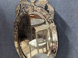 a mirror that is hanging on the wall next to a chair