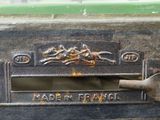 a close up of a metal mailbox with a fork in it