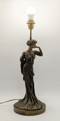 an image of a statue of a woman holding a lamp