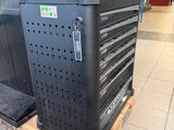 a large black machine sitting on a pallet in a store