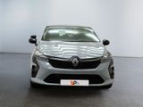 the front view of a silver car parked in a showroom
