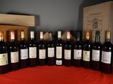 many bottles of wine sitting on a table next to a box
