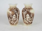 two vases that are sitting on a table