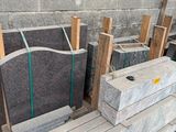 many pieces of granite sitting on a pallet in a warehouse