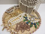 a basket with many different types of jewelry on it