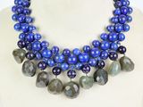 a close up of a necklace on a mannequin with blue beads