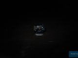 a small toy truck that is sitting in the dark
