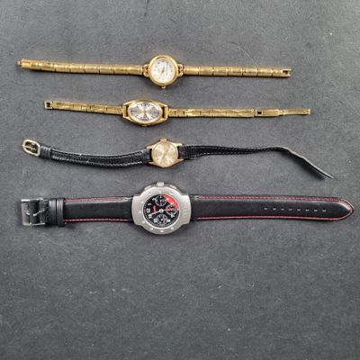 three watches are sitting on a table next to each other